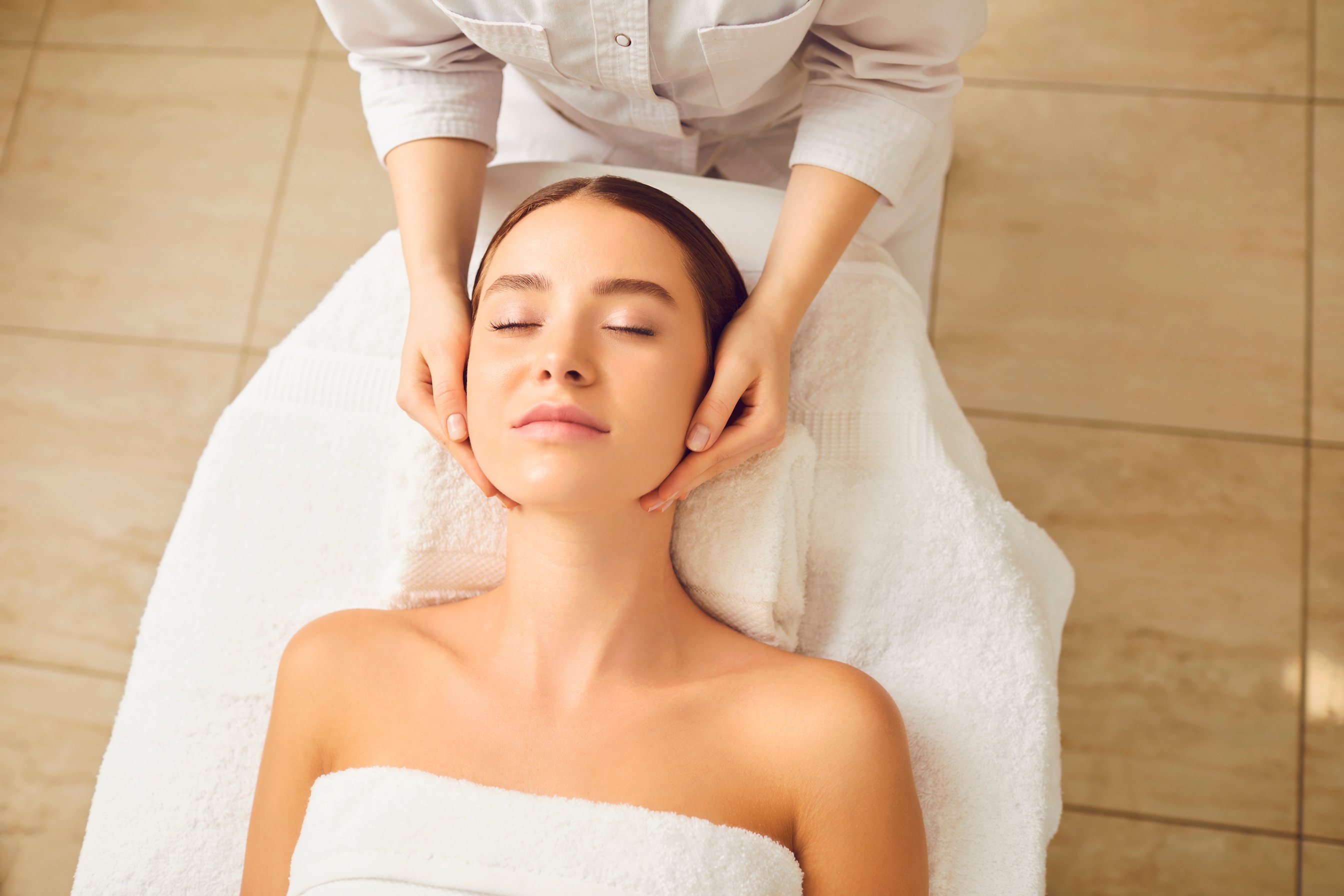 Face Massage to Young Woman Close up.